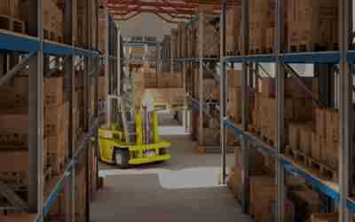 A warehouse with a yellow forklift and boxes.