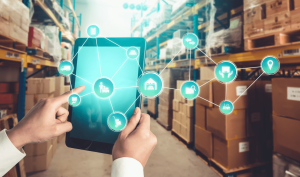 A person utilizing a tablet for warehouse management.