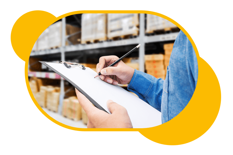 A man holding a clipboard in a warehouse.