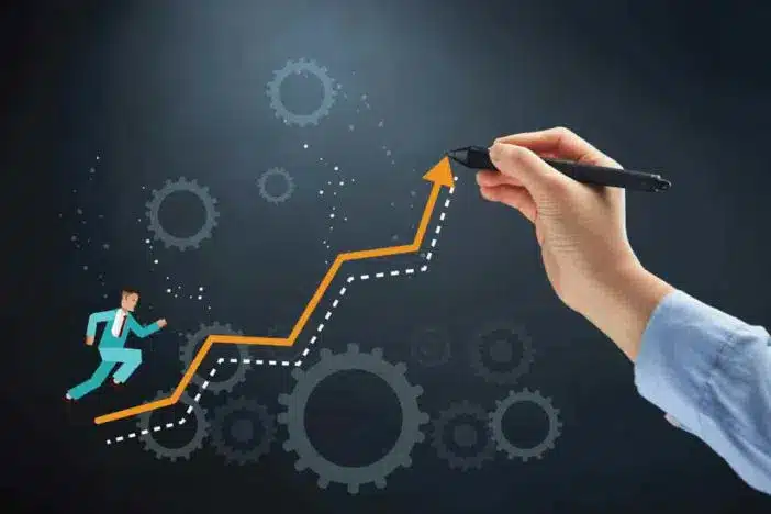 A hand drawing an arrow with a businessman on it representing the logistics of healthcare.