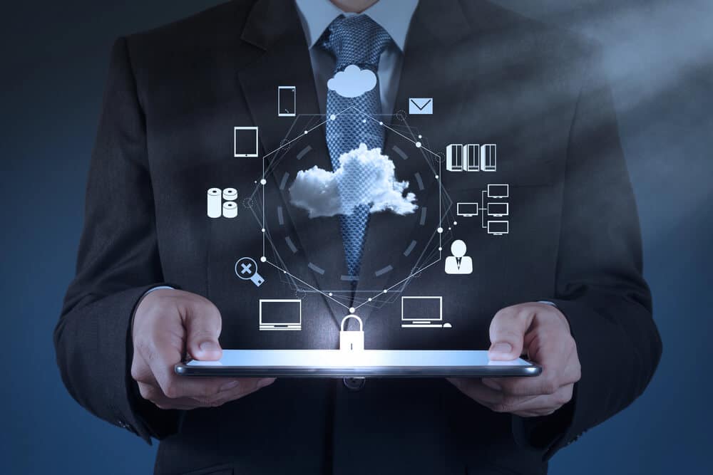A person in a suit holds a tablet displaying digital cloud computing icons, representing data storage, network, and security concepts with a focus on Salesforce Fulfillment Solution.