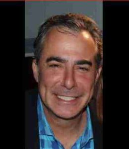 An image of a man smiling for the camera.